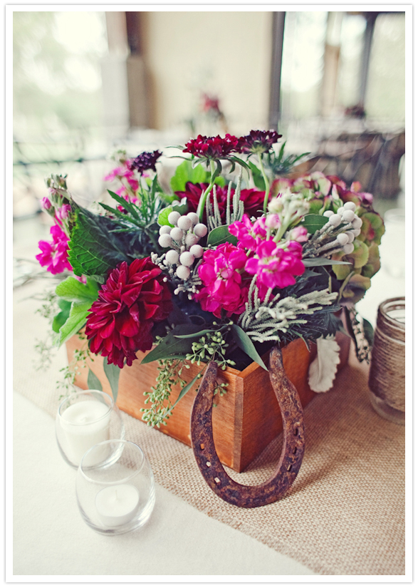 rusted horseshoe and planter box floral arrangement