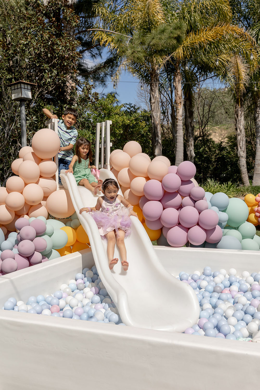 pastel balloon decorations on slide to ball pit