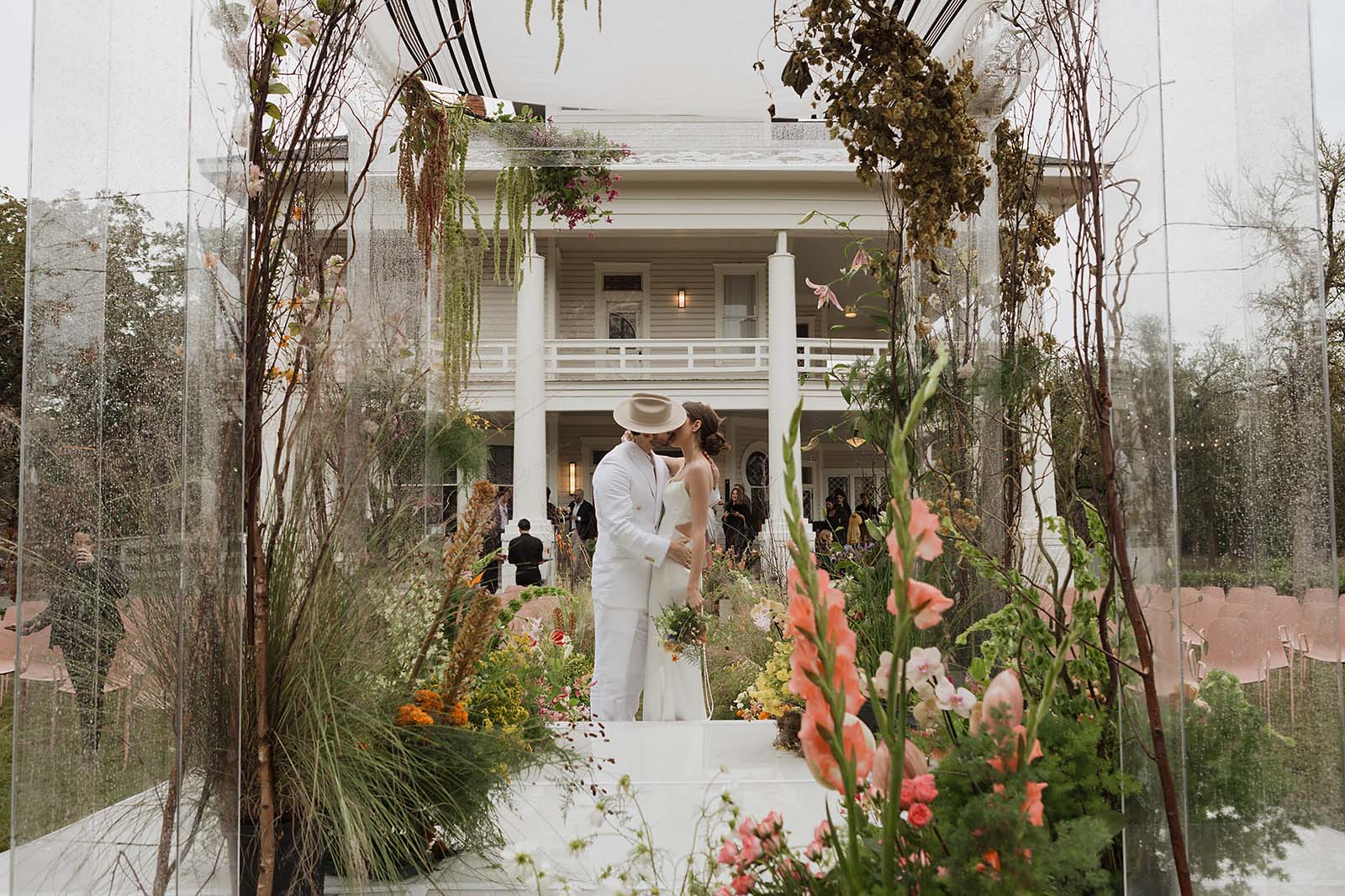 wedding portraits at tropical floral chuppah in Austin wedding at The Grand Lady