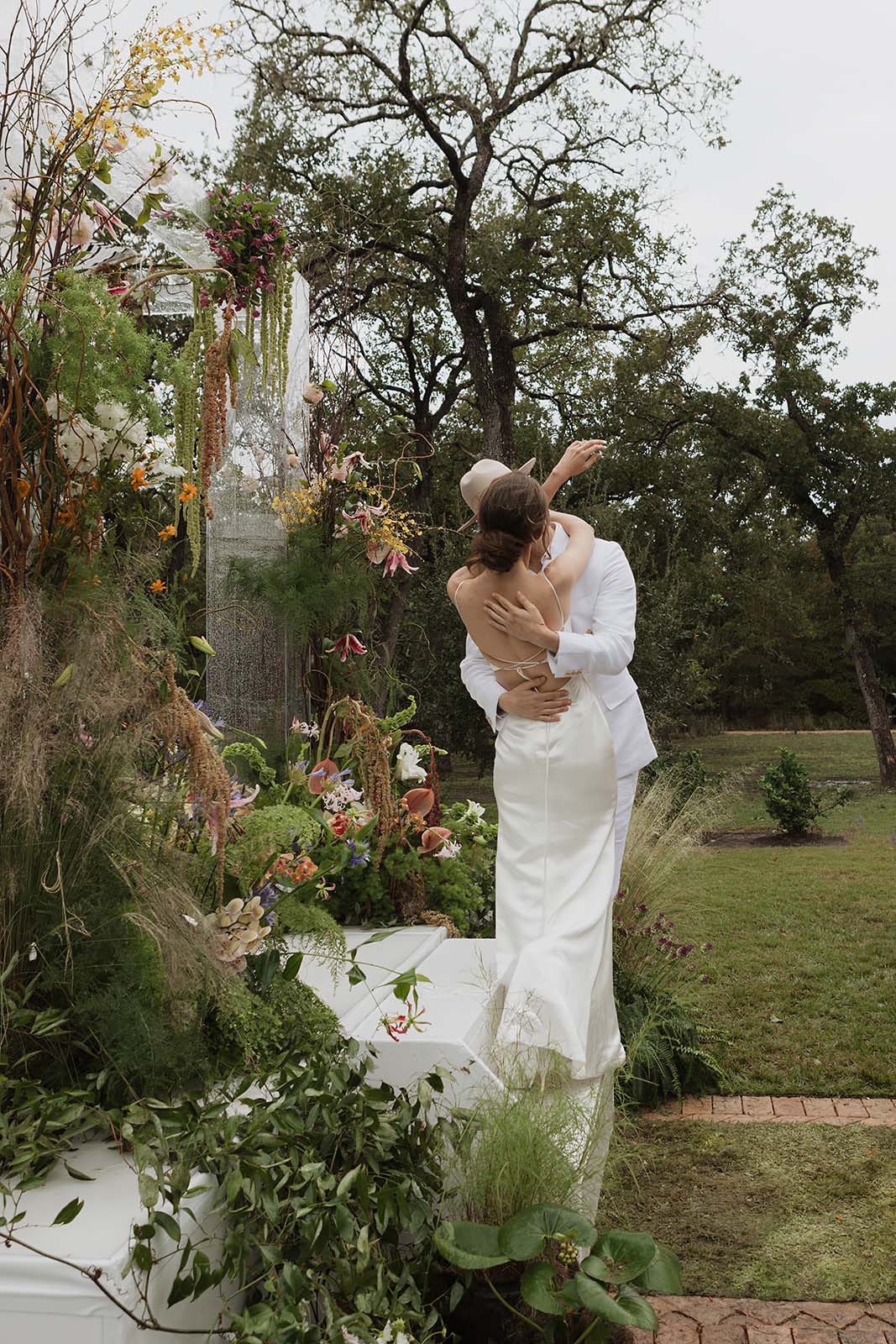 wedding portraits at tropical floral chuppah in Austin wedding