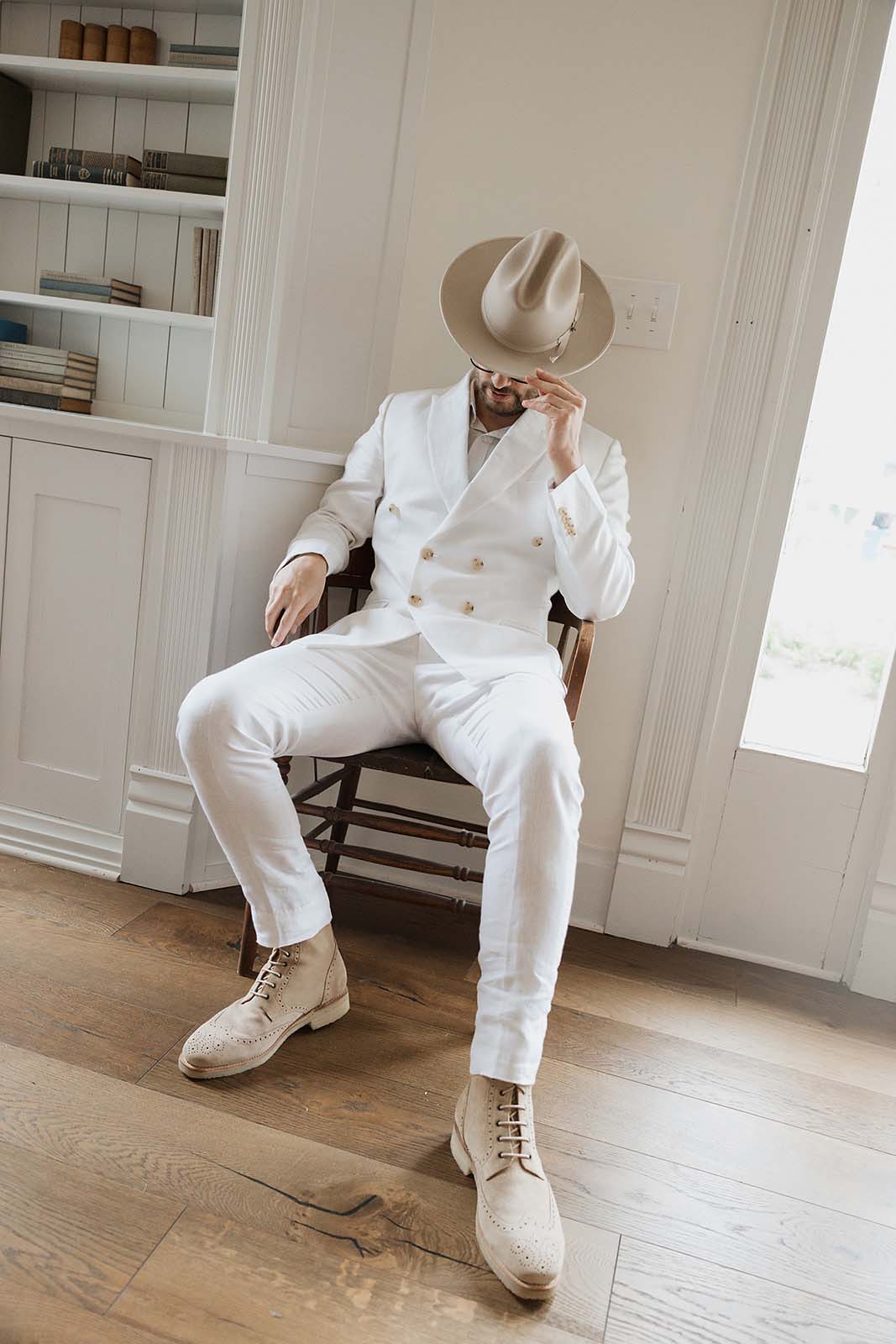 groom in all white with hat at Austin wedding