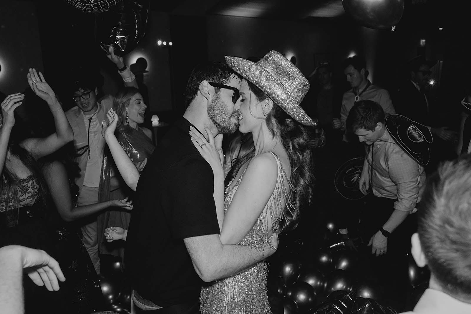 couple dancing with sequin hat at Austin wedding
