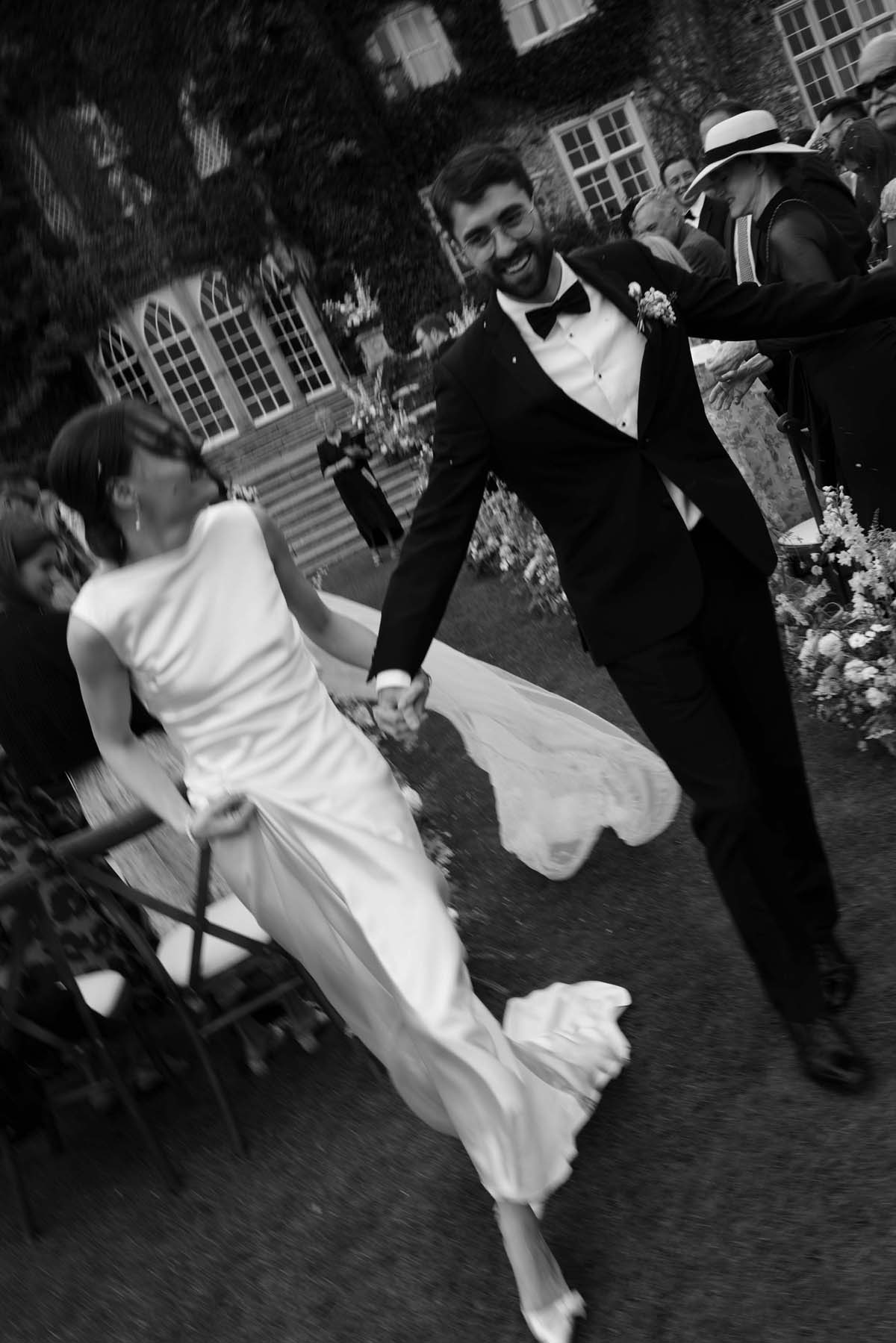 black and white photo of bride and groom after wedding ceremony