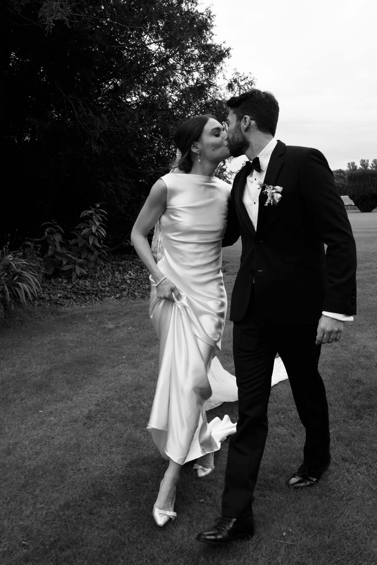 black and white photo of bride and groom after wedding ceremony 