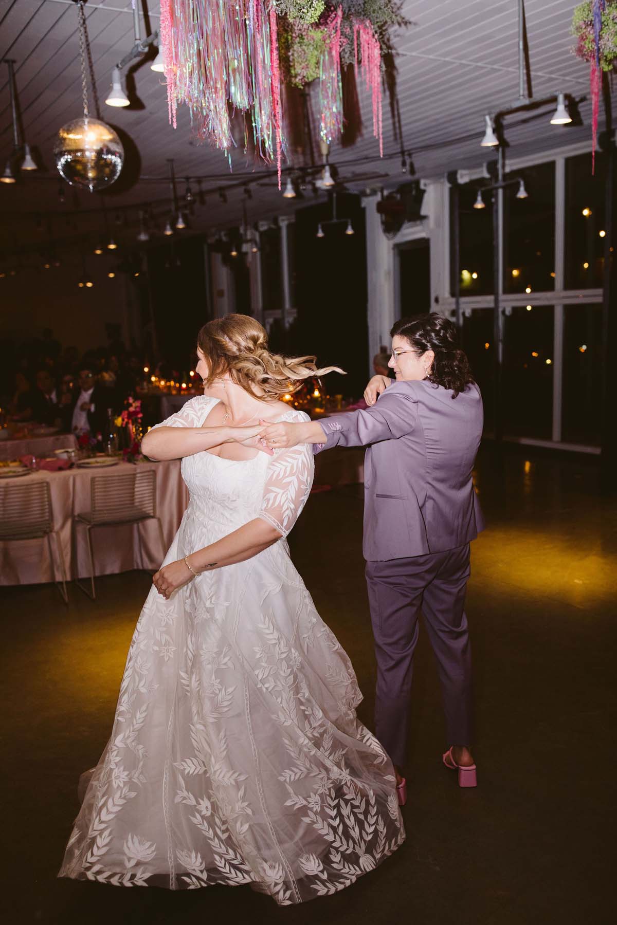 brides dancing at 90s inspired wedding