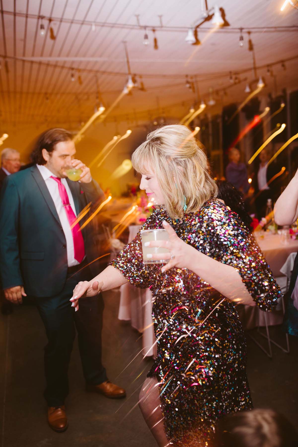 wedding guest dancing in sequin dress