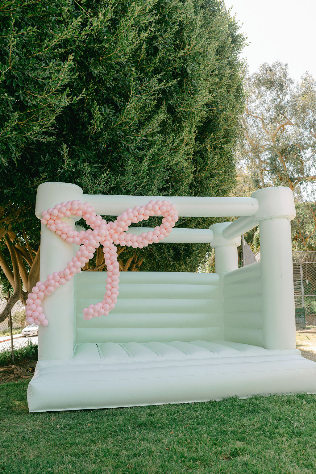 bow balloon decorations on kids bounce house for girls birthday party