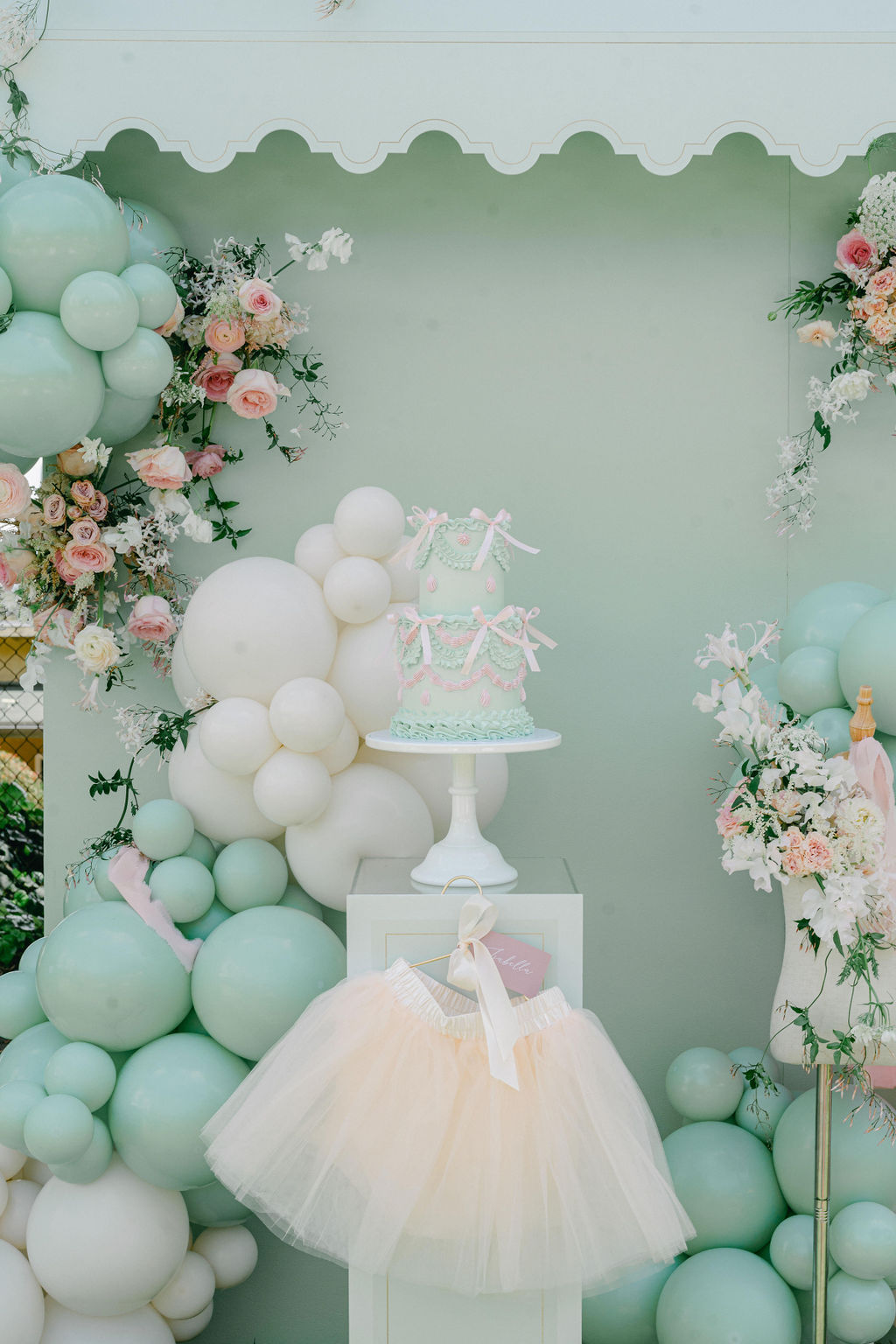 pastel girls birthday cake - mint green with bows and balloon decor