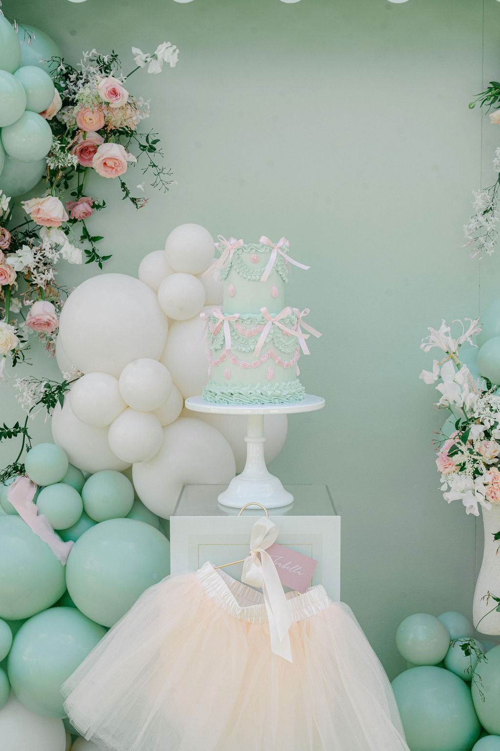 pastel girls birthday cake - mint green with bows and balloon decor