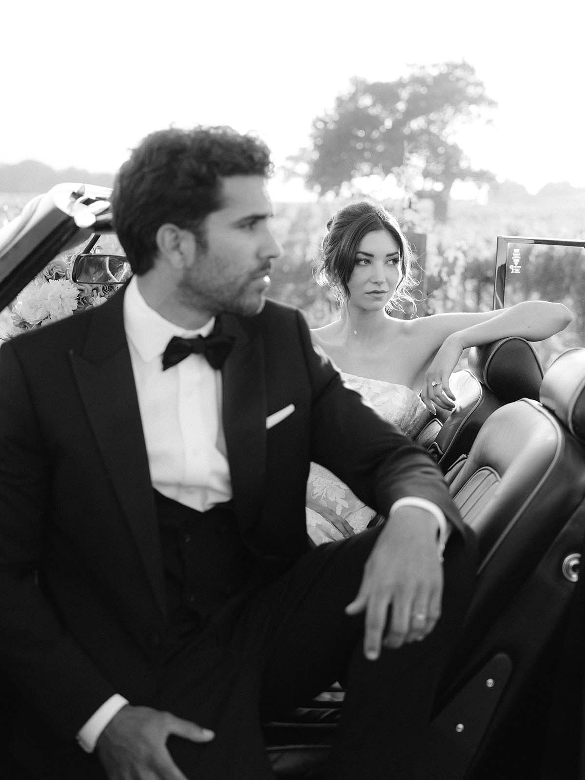 black and white wedding portrait in vintage car