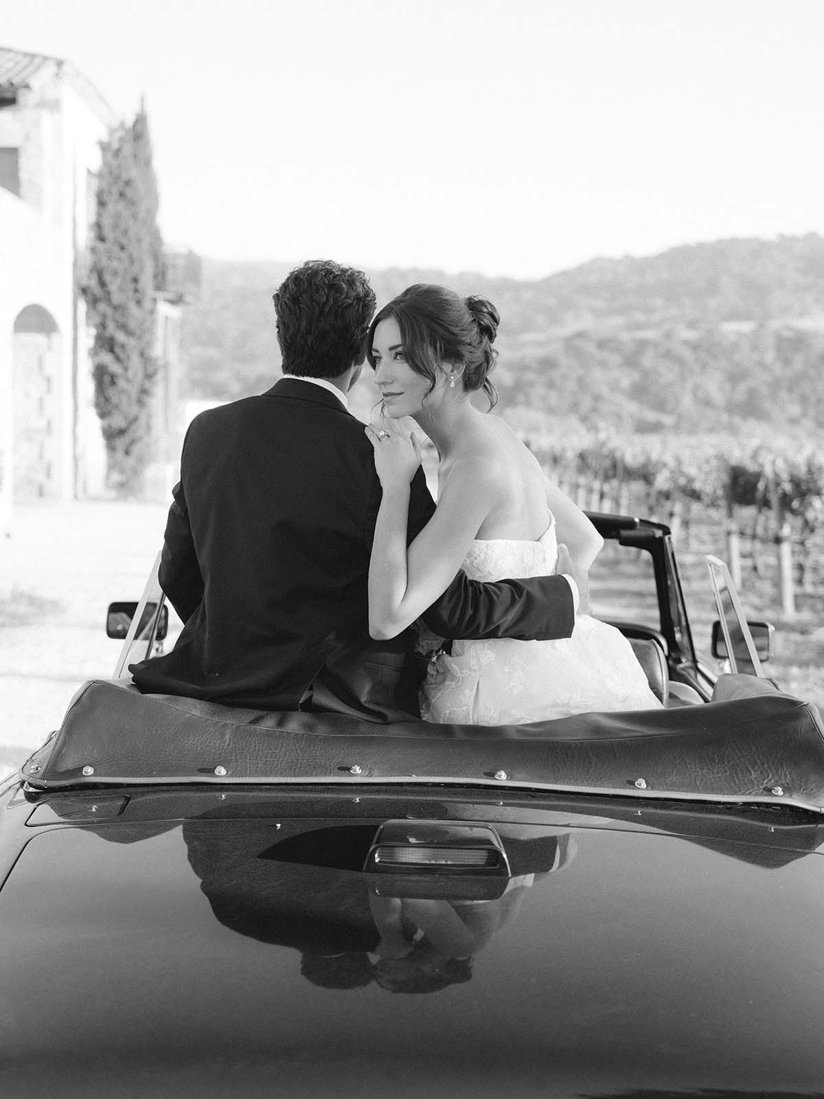 black and white wedding portrait in vintage car