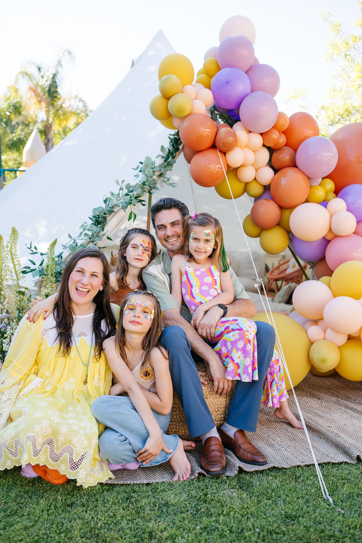 family photos in front of tent at groovy birthday party