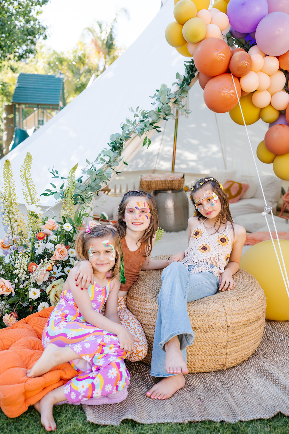 family photos in front of tent at groovy birthday party