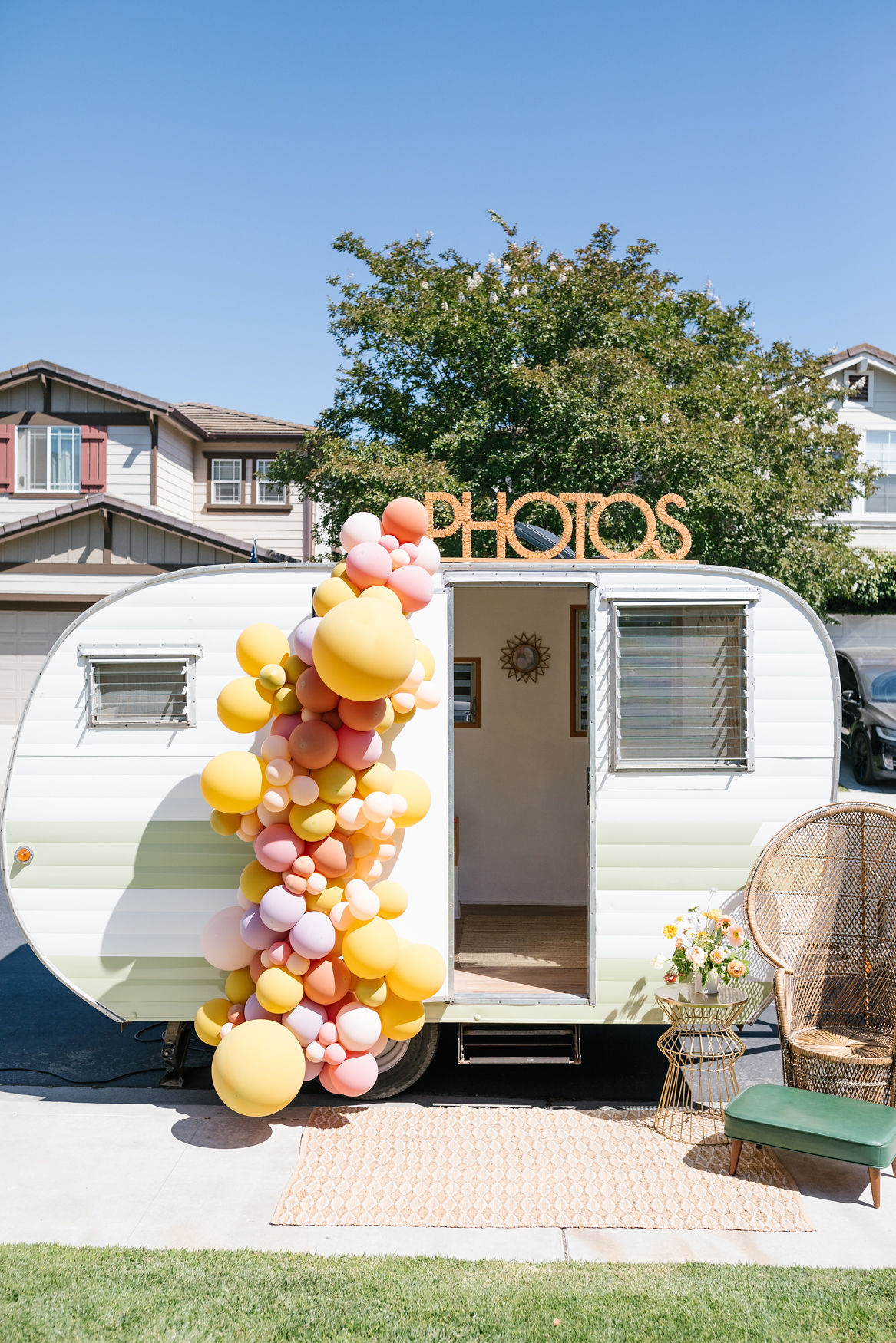 groovy hippie inspired photo booth for 60s 70s inspired birthday party with balloon decorations