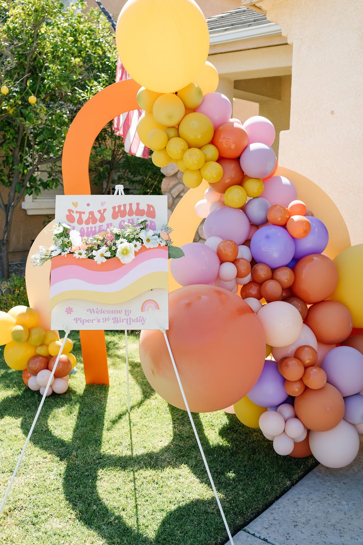 Stay Wild, Flower Child kids birthday welcome sign with balloon decorations