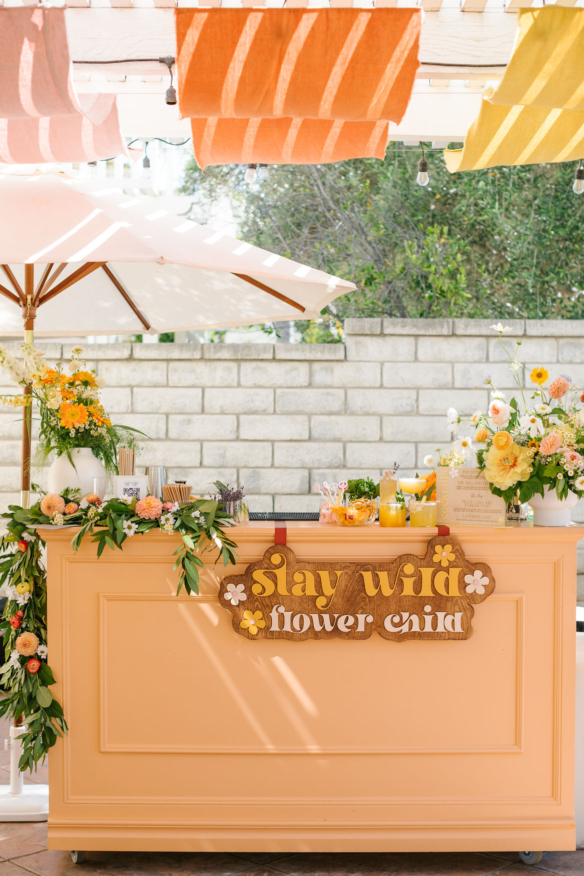 "stay wild flower child" groovy bar decor for party