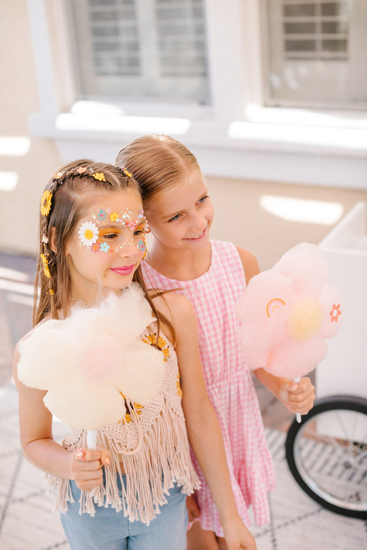 girls at cotton candy station at hippie birthday party