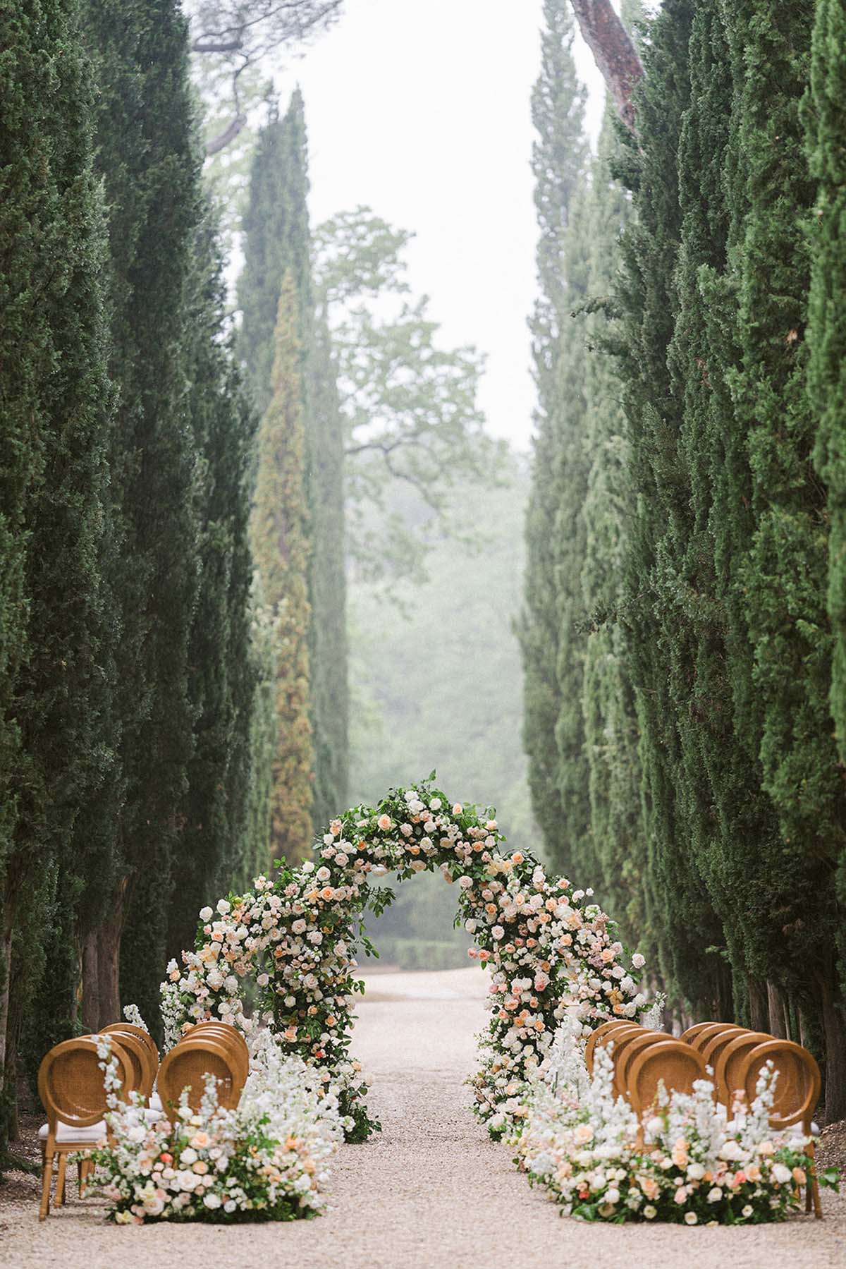 elegant floral arch with roses for wedding ceremony at Château Martinay, France