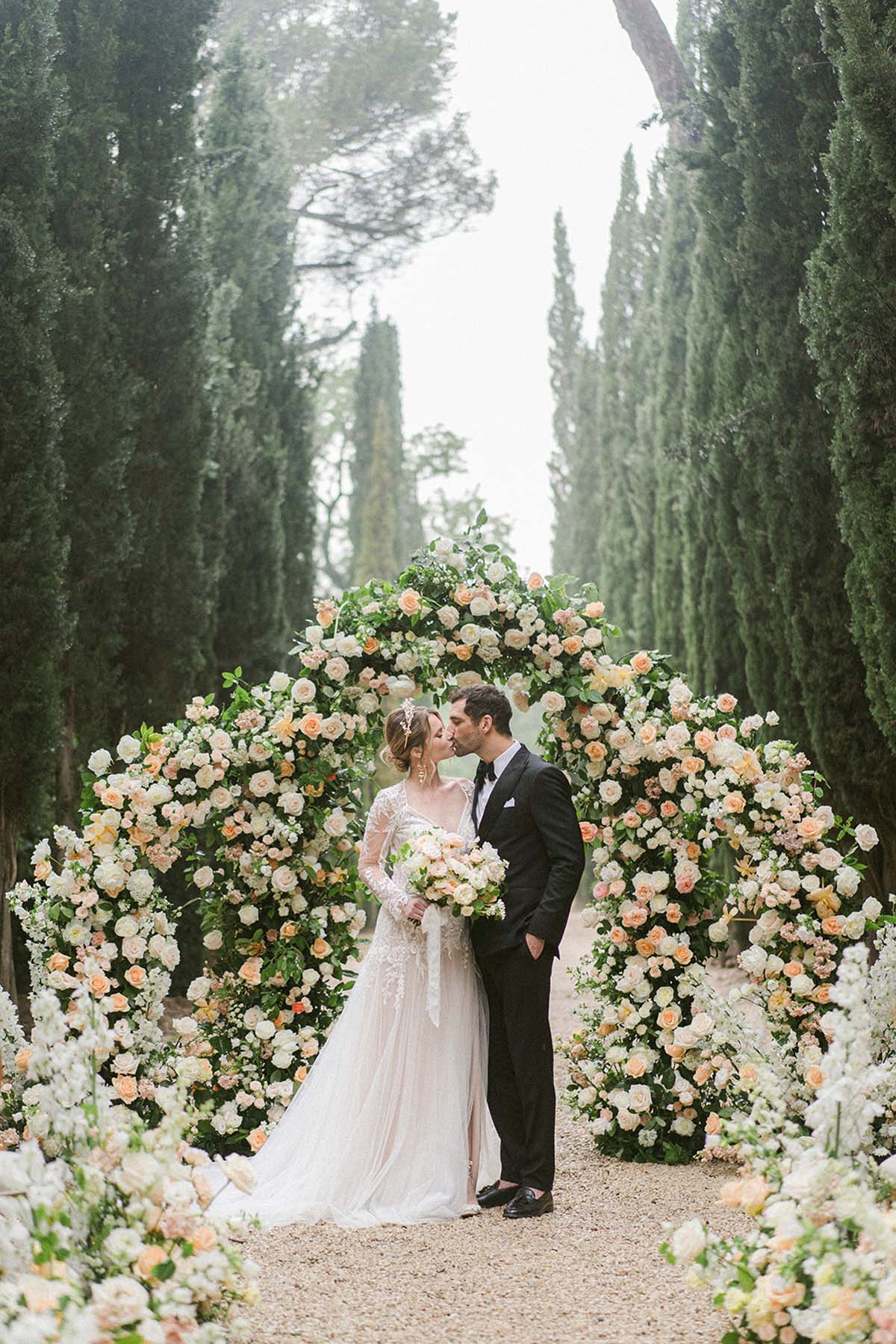 elegant floral arch with roses for wedding ceremony at Château Martinay, France