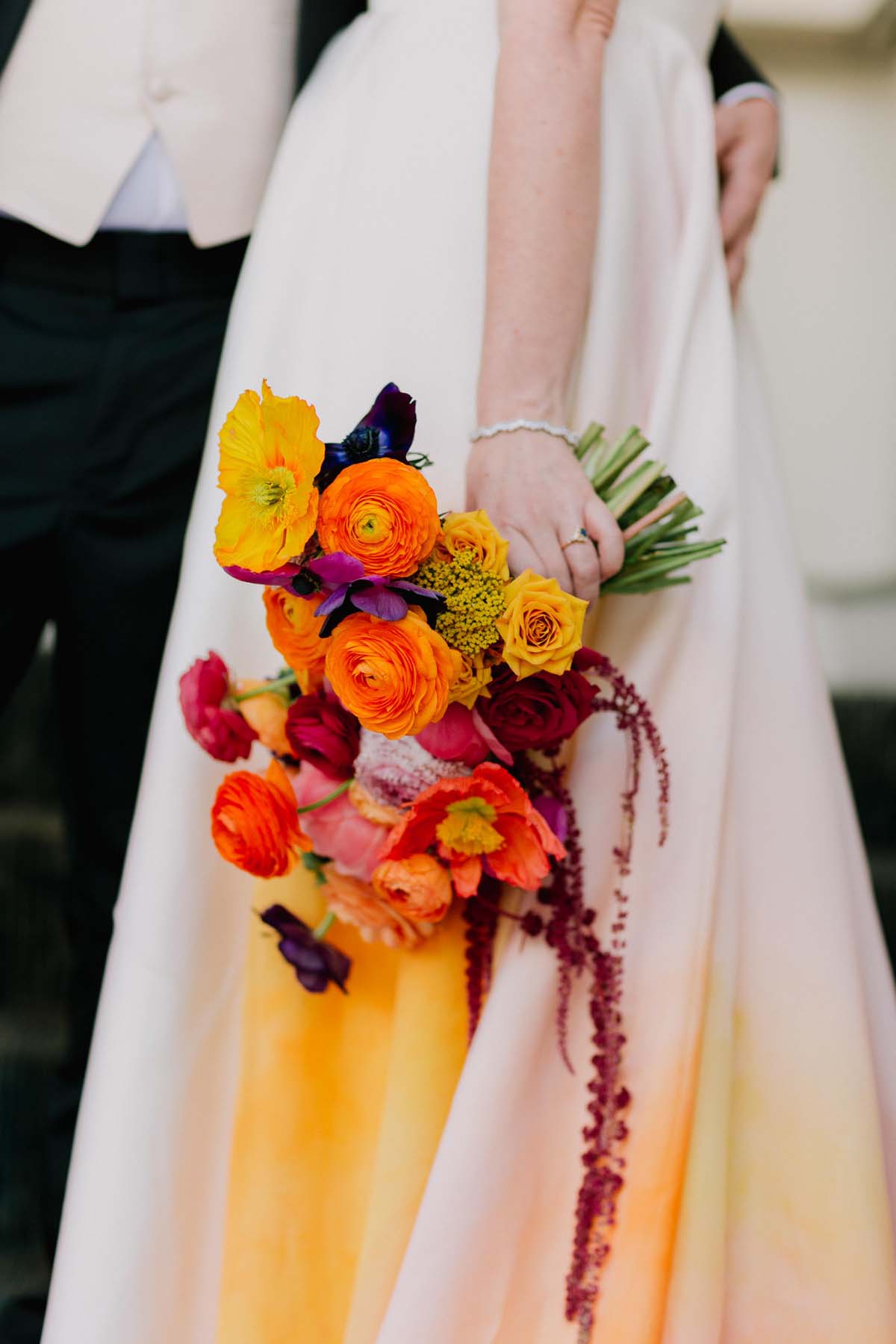 colorful orange and yellow wedding bouquet and dress