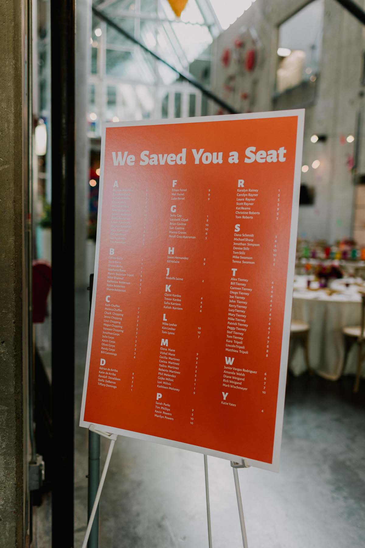 orange seating chart at colorful wedding