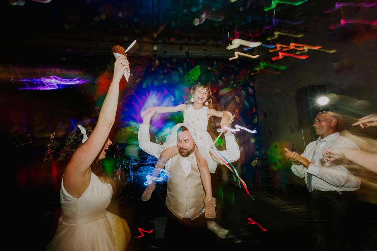 groom dancing with flower girl at wedding