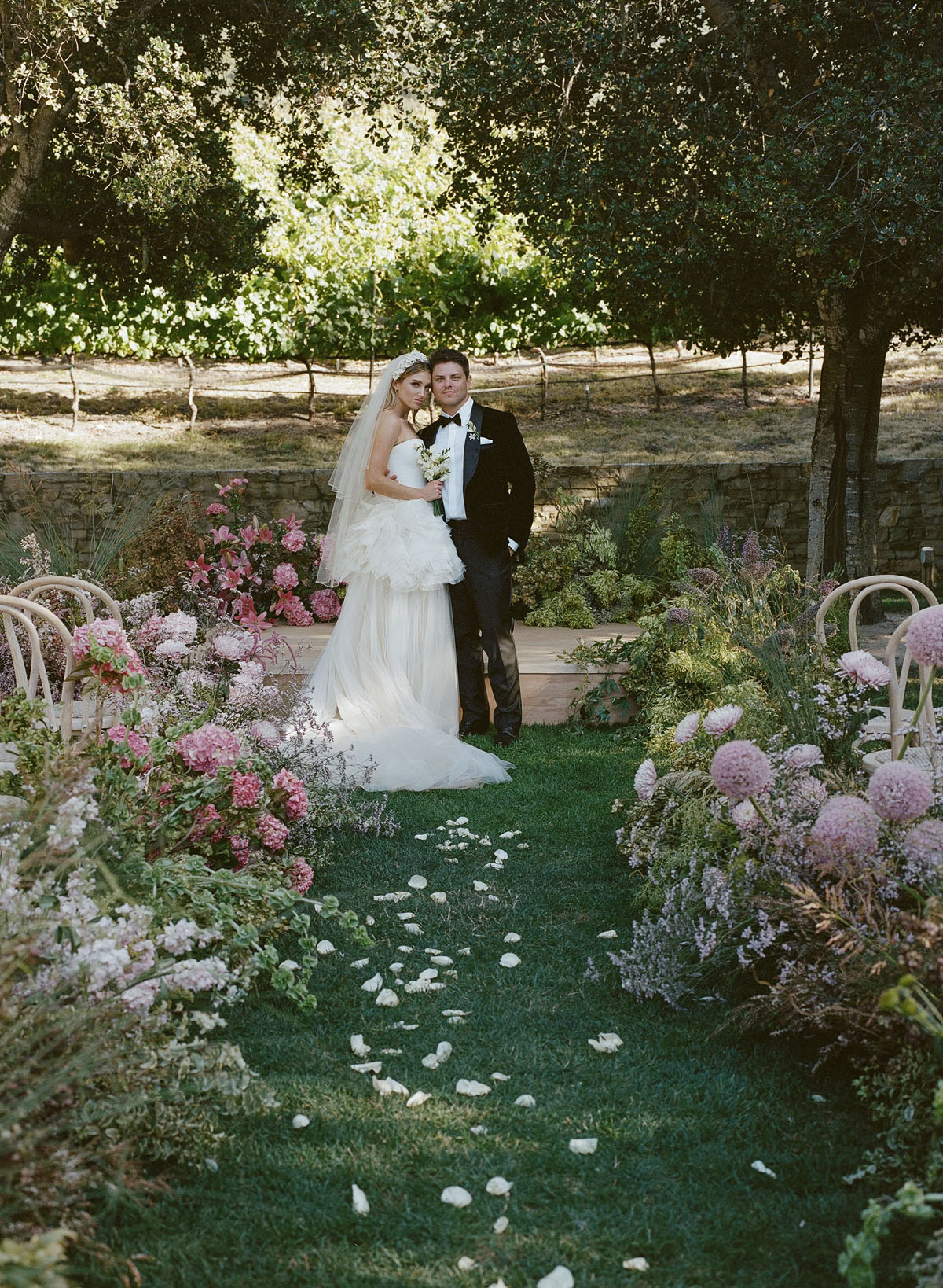 wild, oversized floral arrangements and bride in vera wang at wedding ceremony