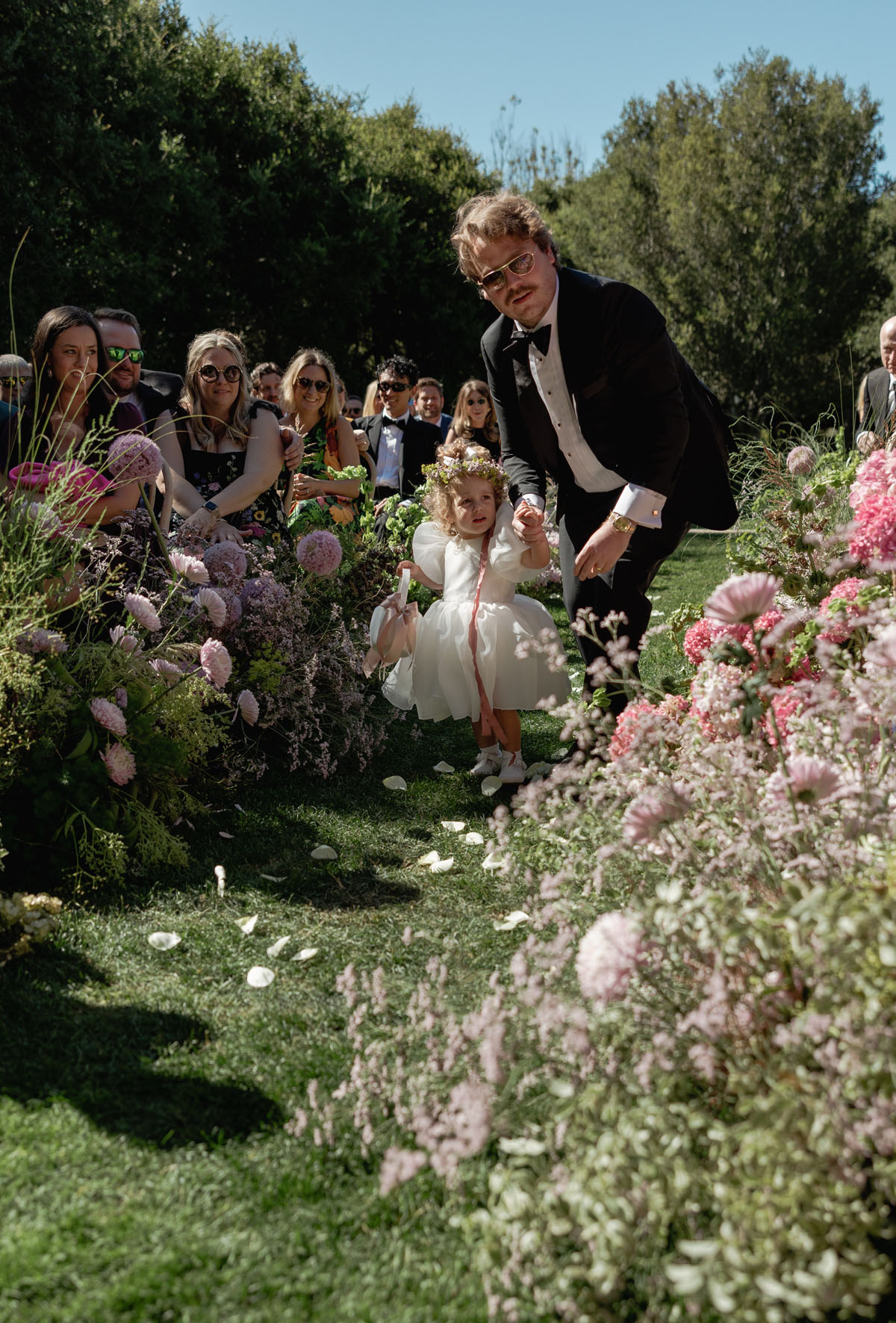 flower girl walking down ceremony aisle