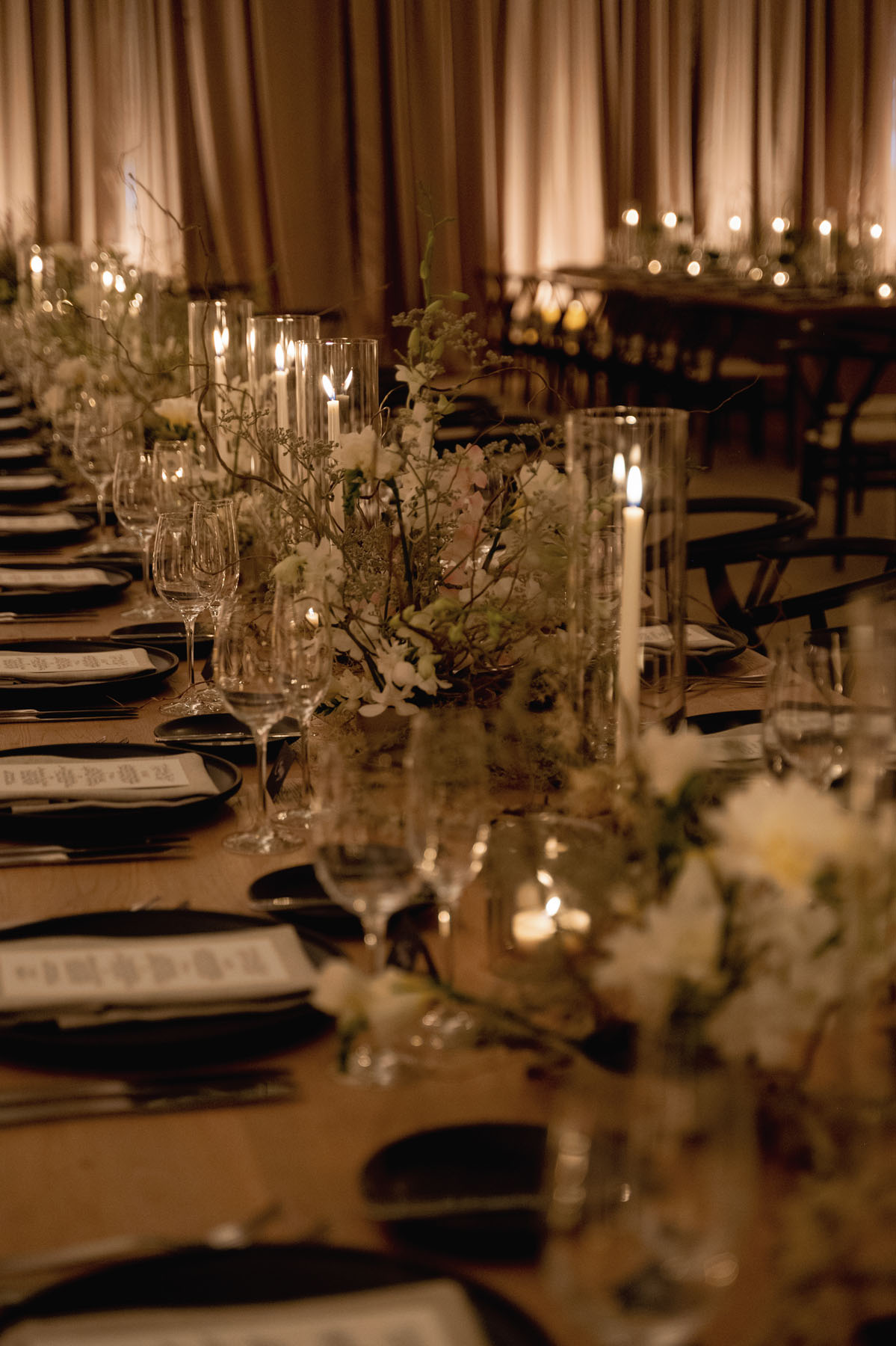 moody romantic tablescape with candles for indoor wedding reception