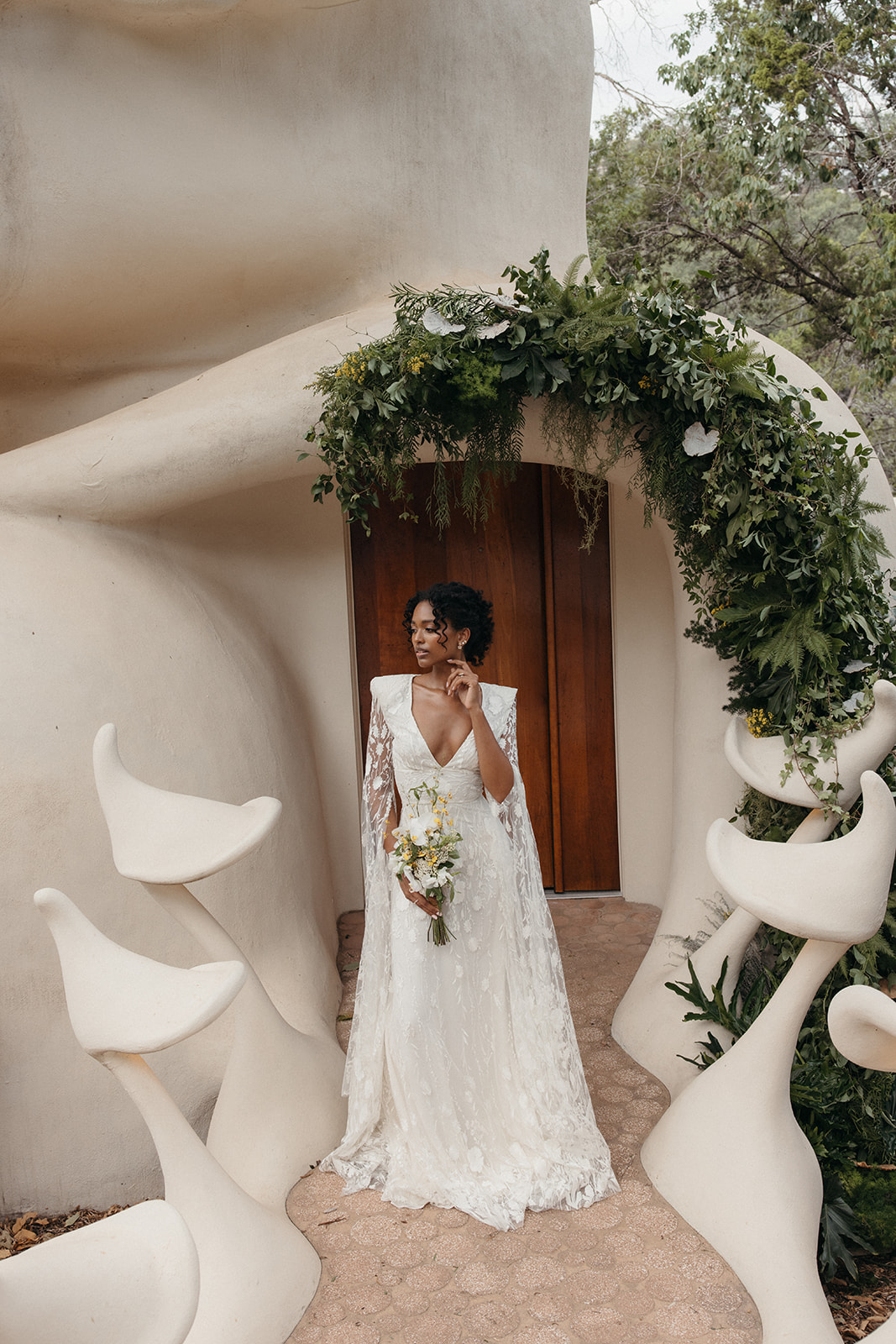 bride in lace cape dress at unique elopement venue in Austin