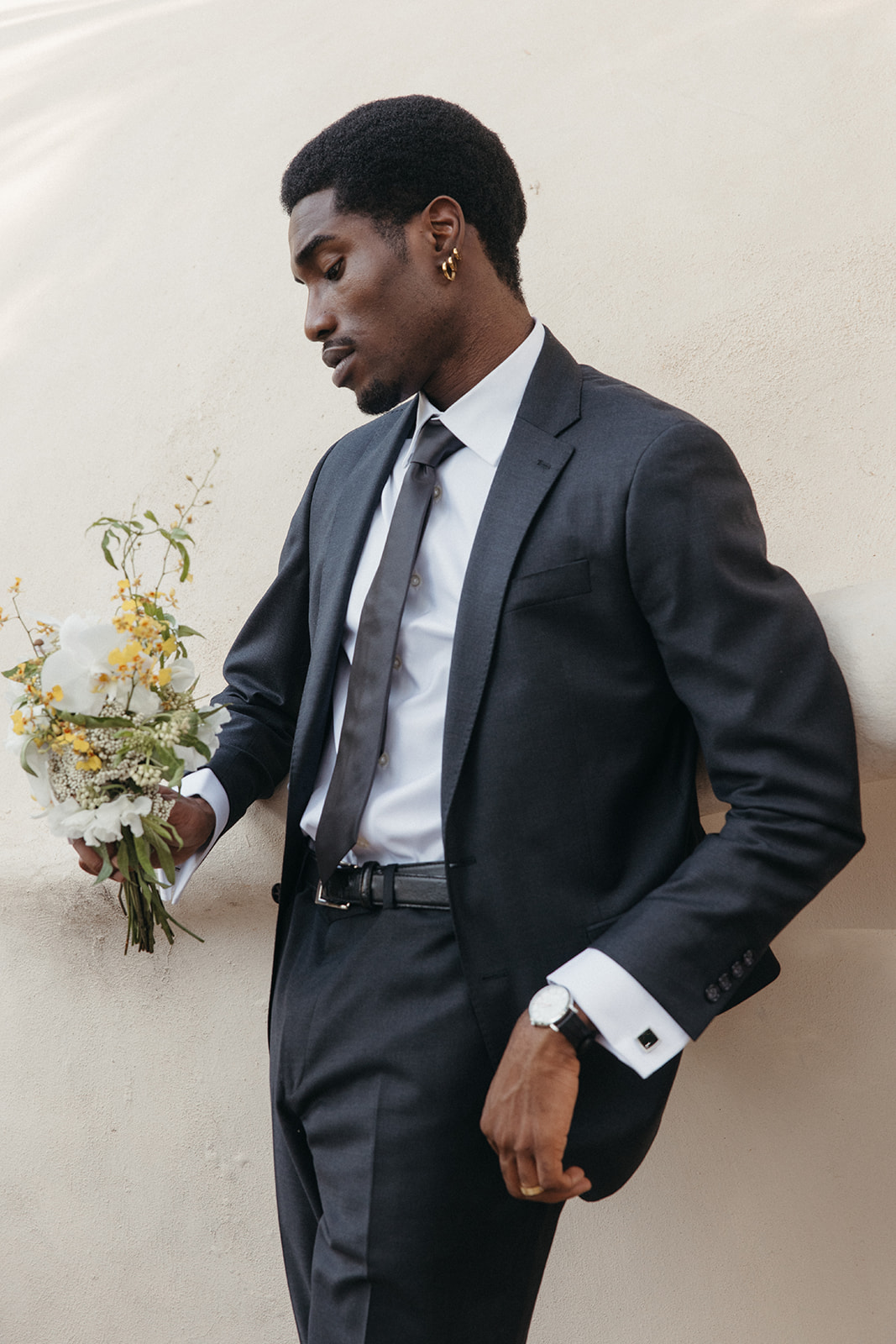 groom wearing charcoal gray suit and tie