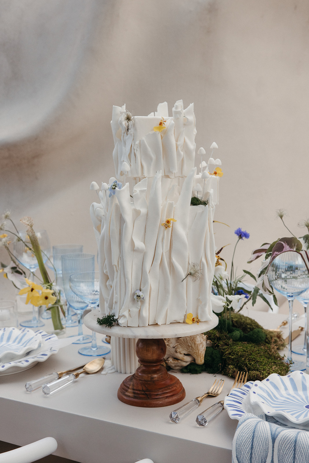 textural wedding cake with flowers and mushrooms