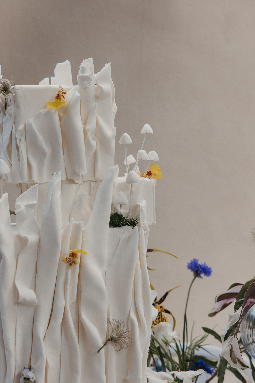 textural wedding cake with flowers and mushrooms