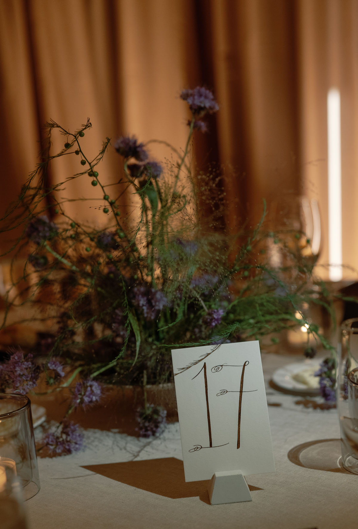 funky floral arrangements and calligraphy table numbers for black and white fall wedding