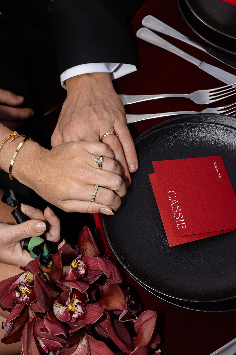 couple holding hands with wedding rings