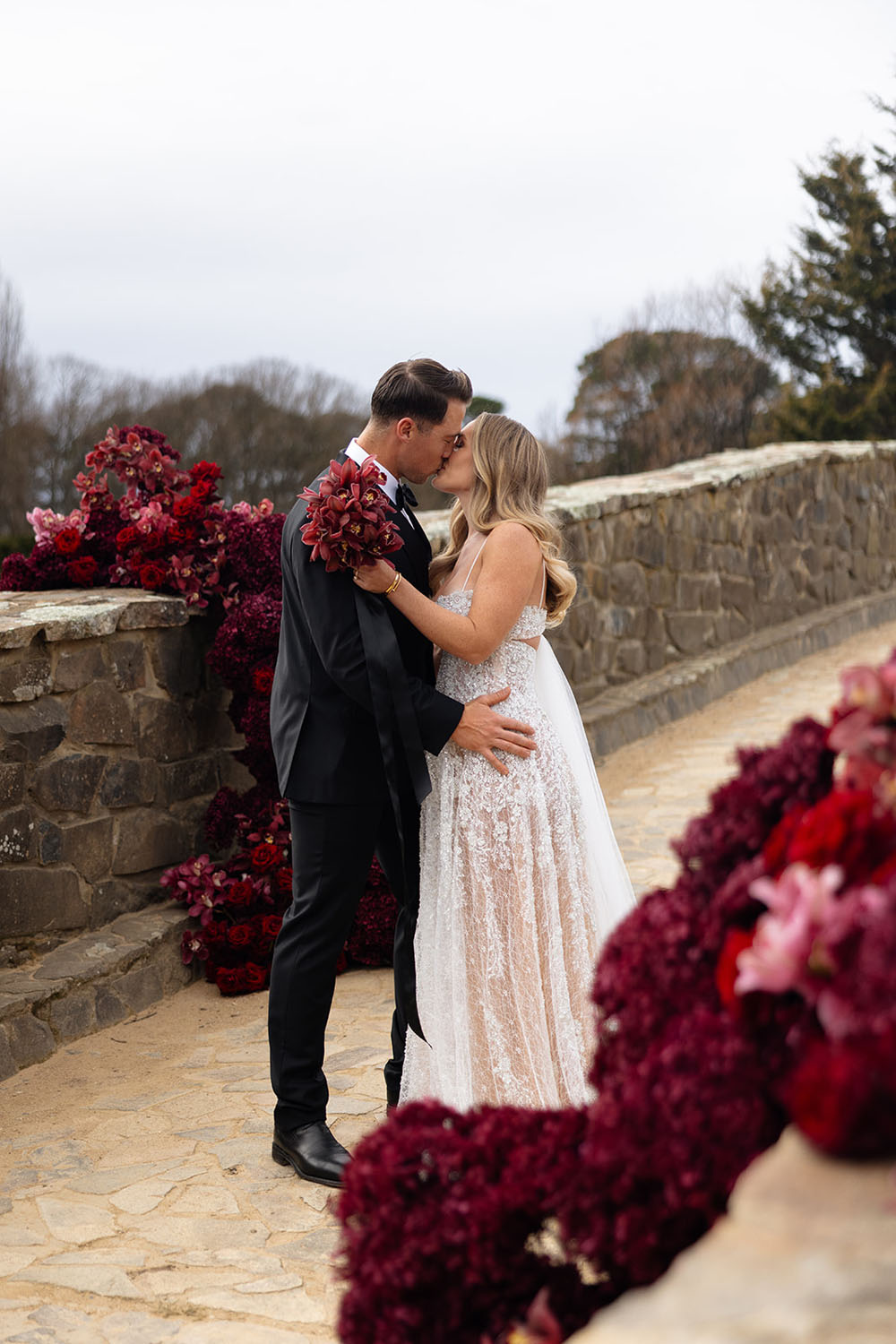 red wedding flowers and sparkly wedding gown by ASTON Bridal