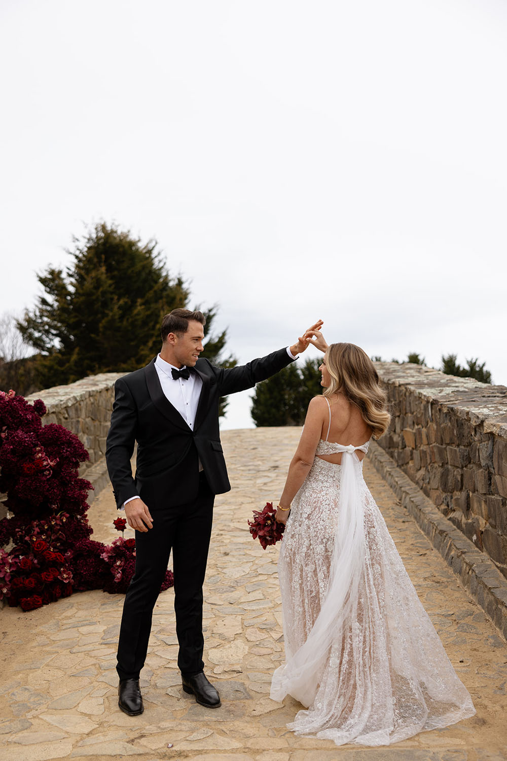 red wedding flowers and sparkly wedding gown by ASTON Bridal