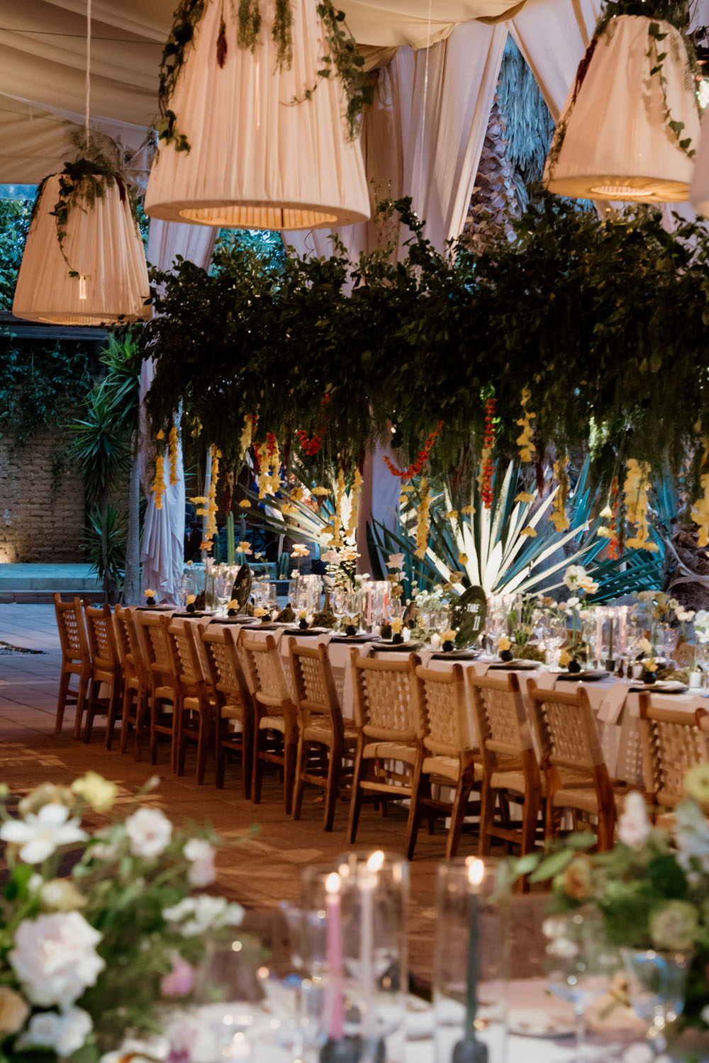 lush floral wedding reception with lantern lights