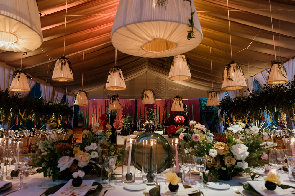 lush floral wedding reception with lantern lights